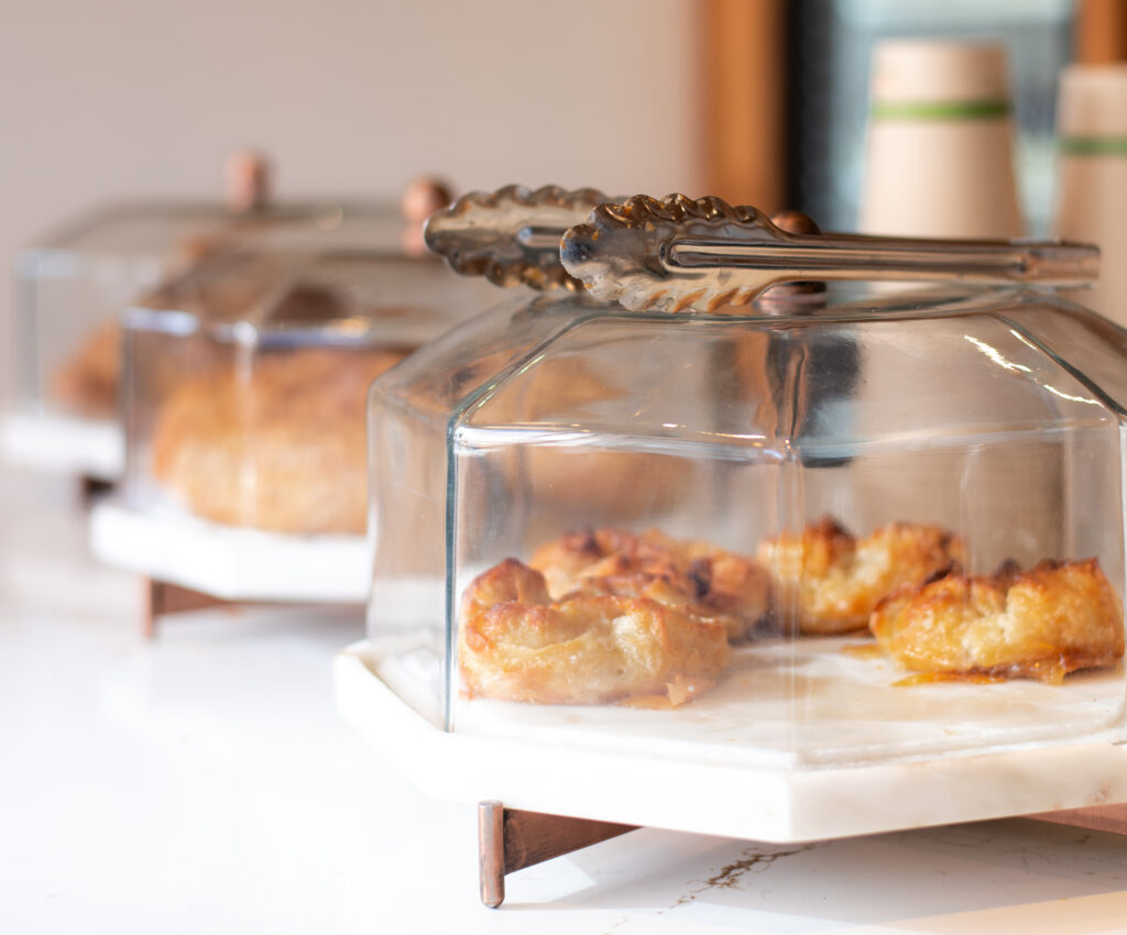 A display of pastries under a glass dome