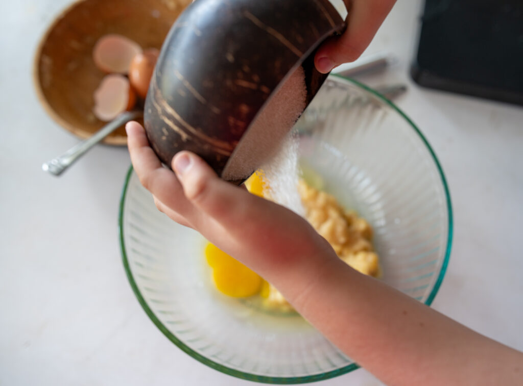 pouring sugar in a bowl